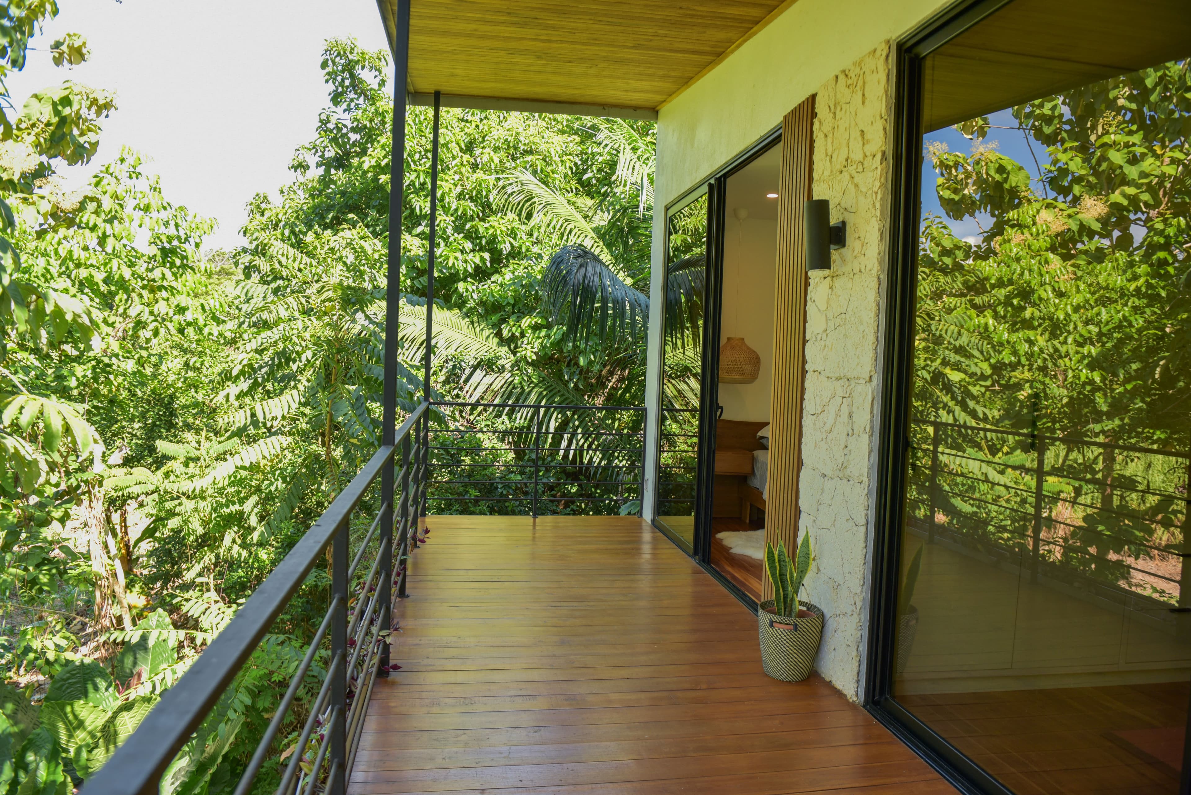 Upper rear porch overlooking tropical gardens