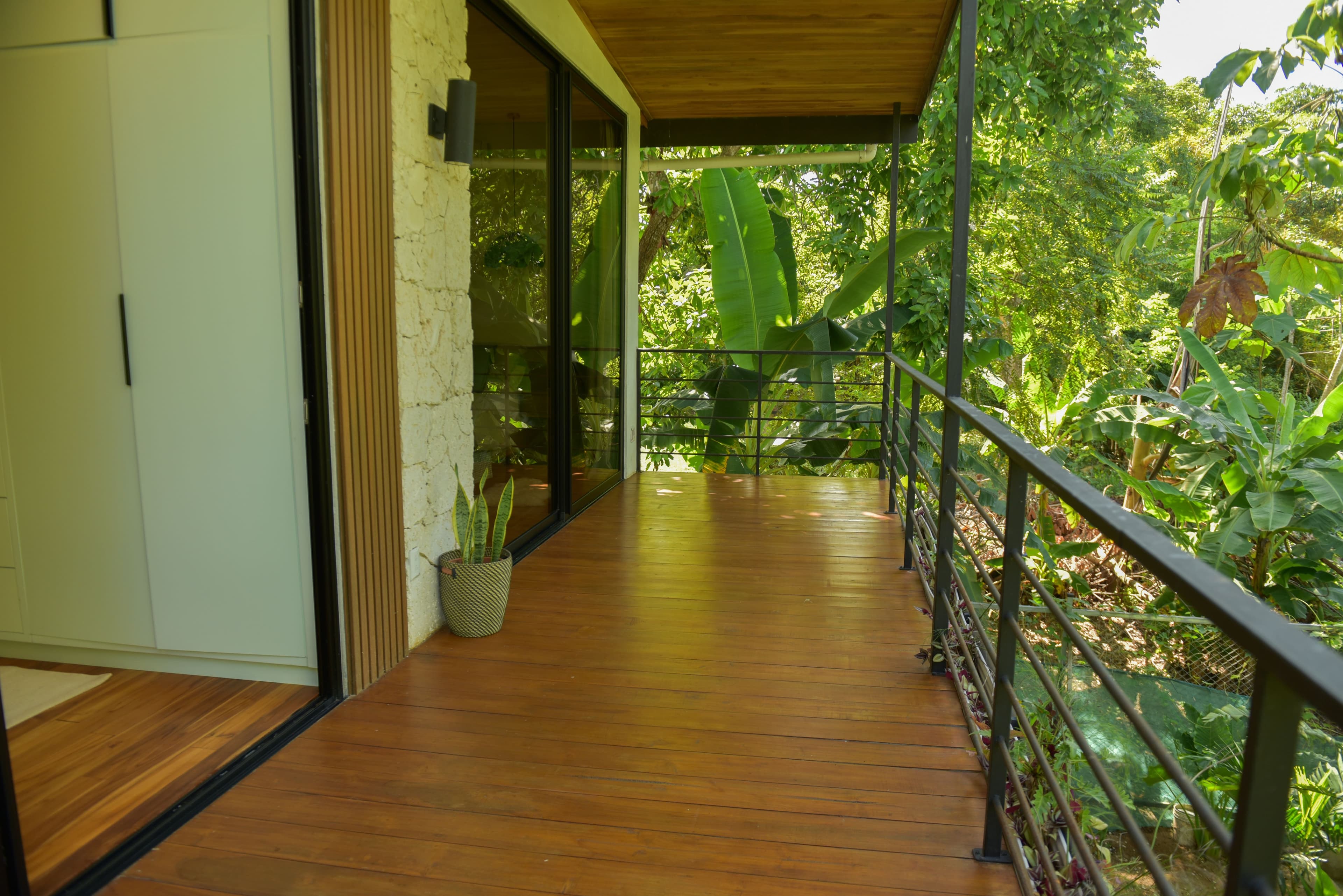 Rear upper terrace with lush outdoor surroundings