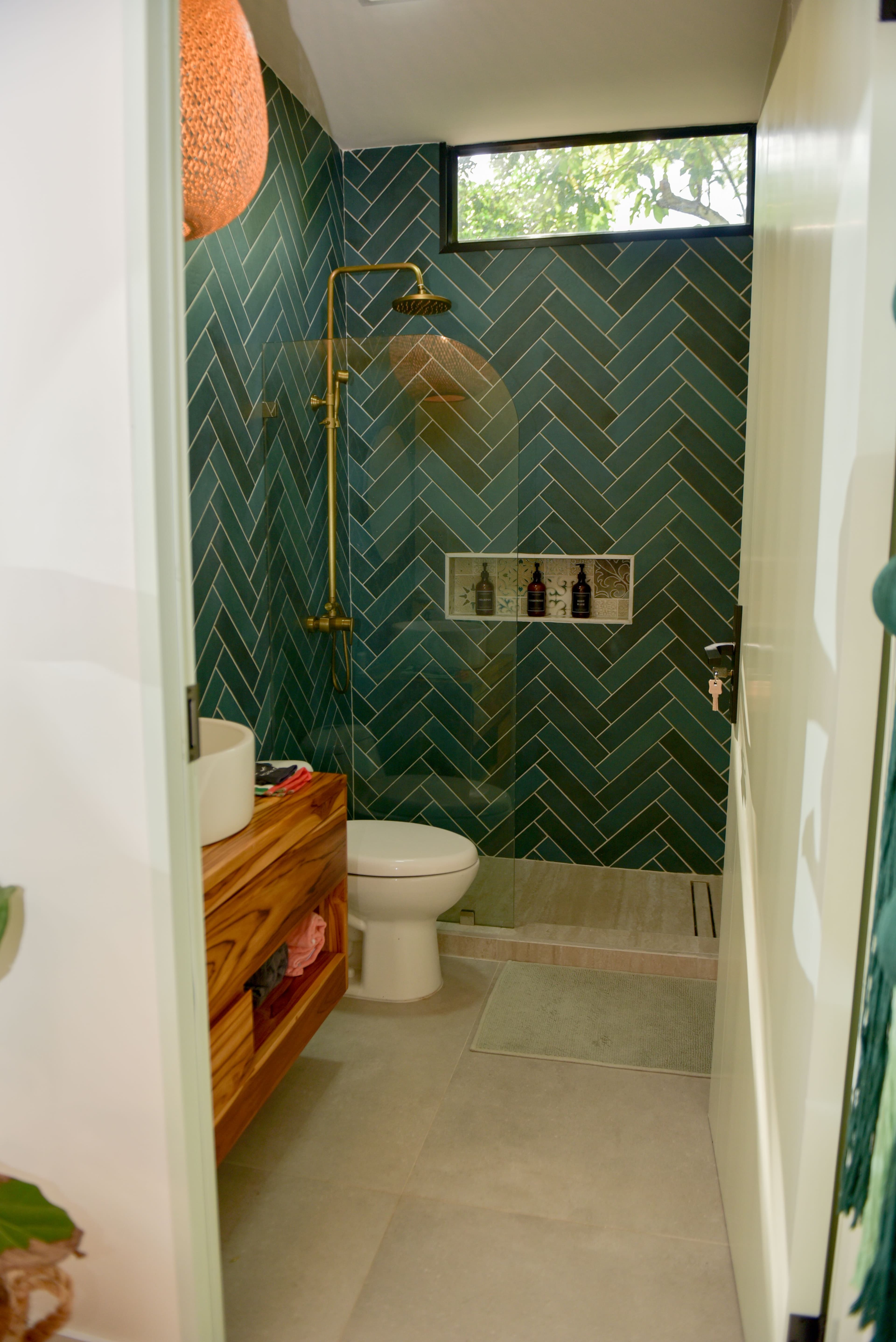 Ground-floor full bathroom with teal herringbone tile