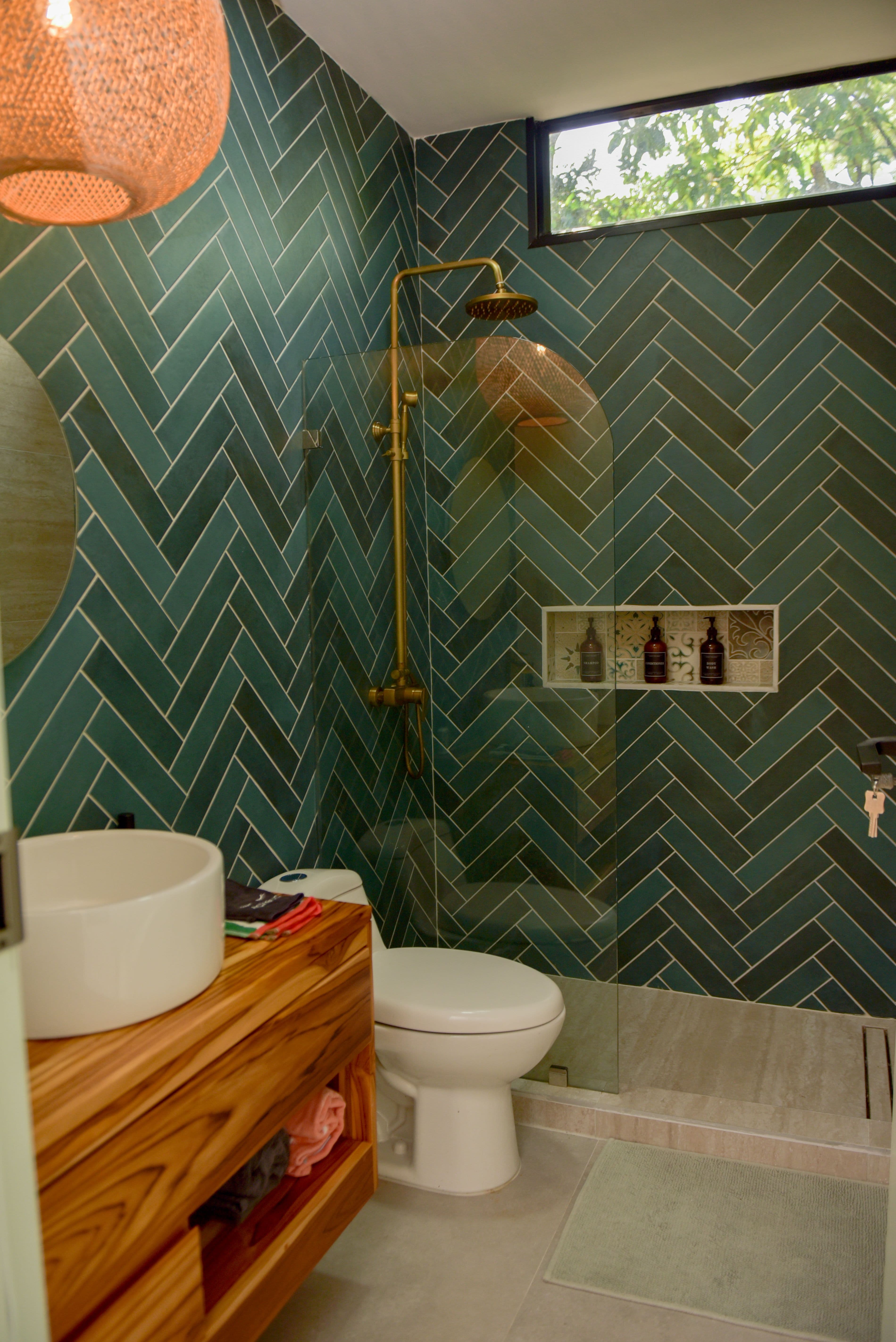 Ground-floor full bathroom with teal herringbone tile and modern fixtures
